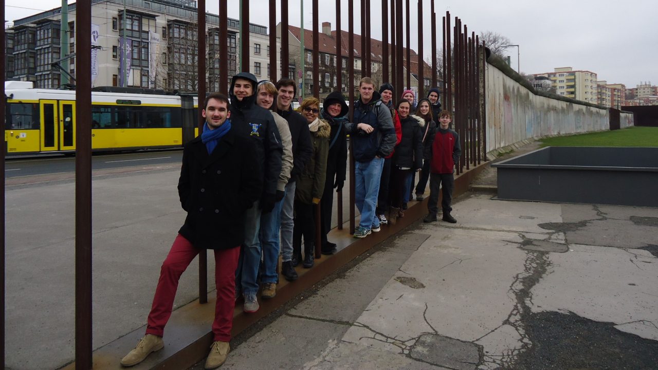 Students studying abroad in Germany, lined up along a fence outside
