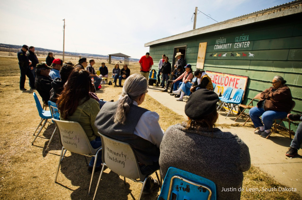 A Native American Tribe sitting outside a community center in Nevada