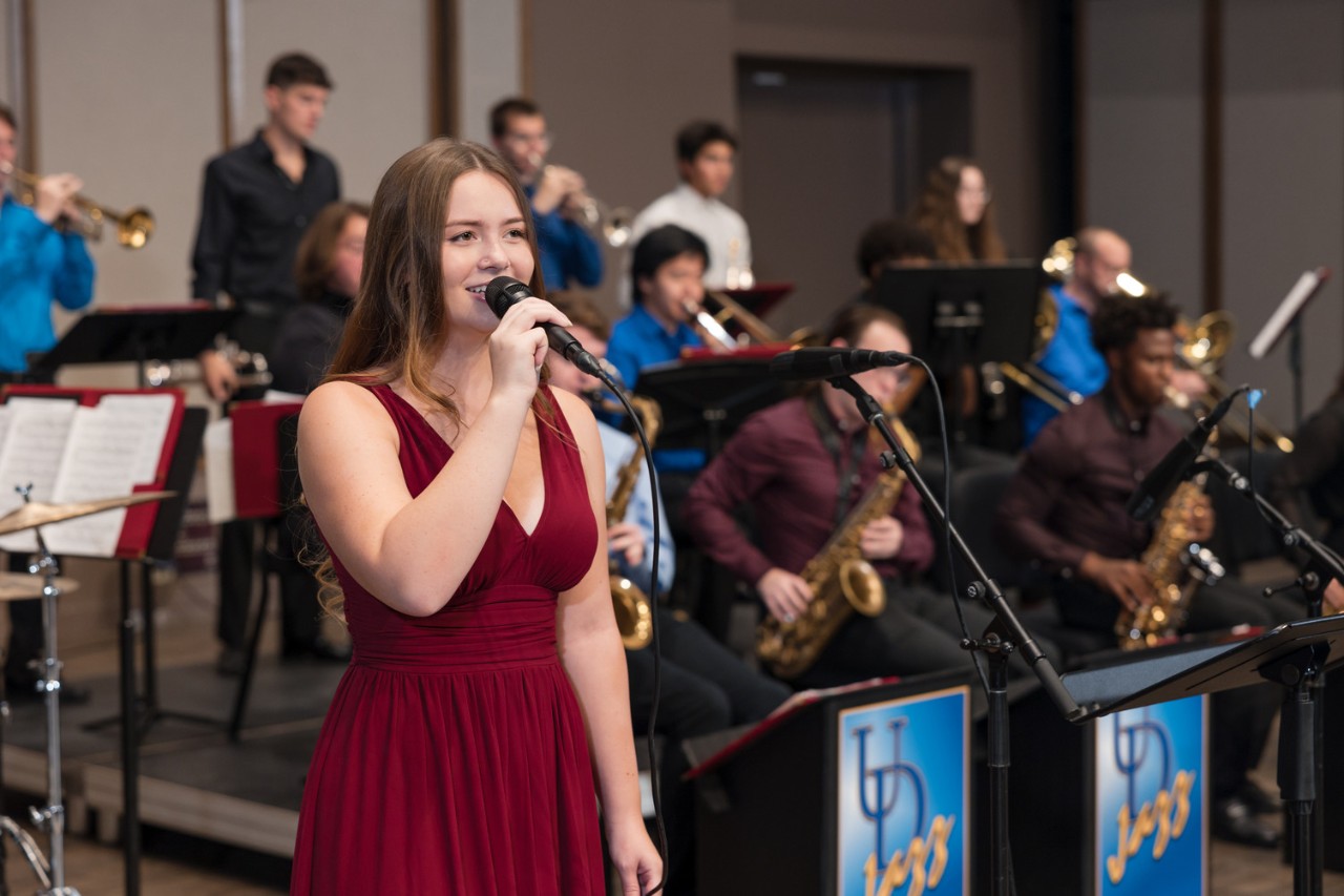 Jazz muscian singing alongside a jazz band at University of Delaware