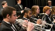 Students playing trumpets in an orchestra setting