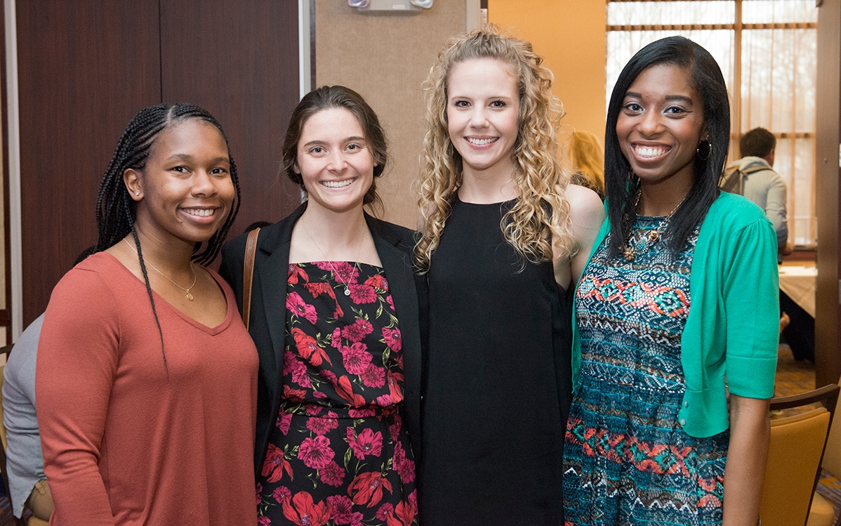Four University of Delaware undergraduate students, dressed in semi-formal attire, attend the Department of Sociology and Criminal Justice awards banquet, hosted by the Alpha Kappa Delta Honor Society. 
