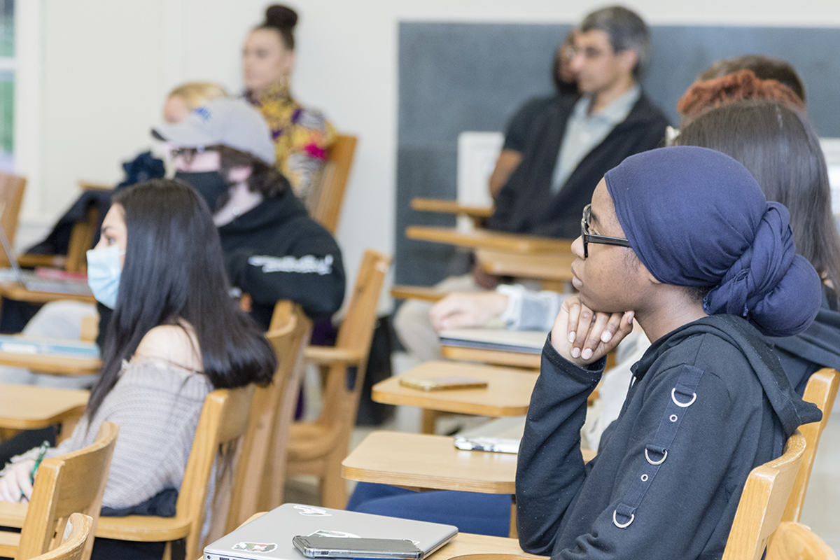 University of Delaware students sit in a classroom and listen to iPoems during a teach-in event about prison reentry, held in April 2022.