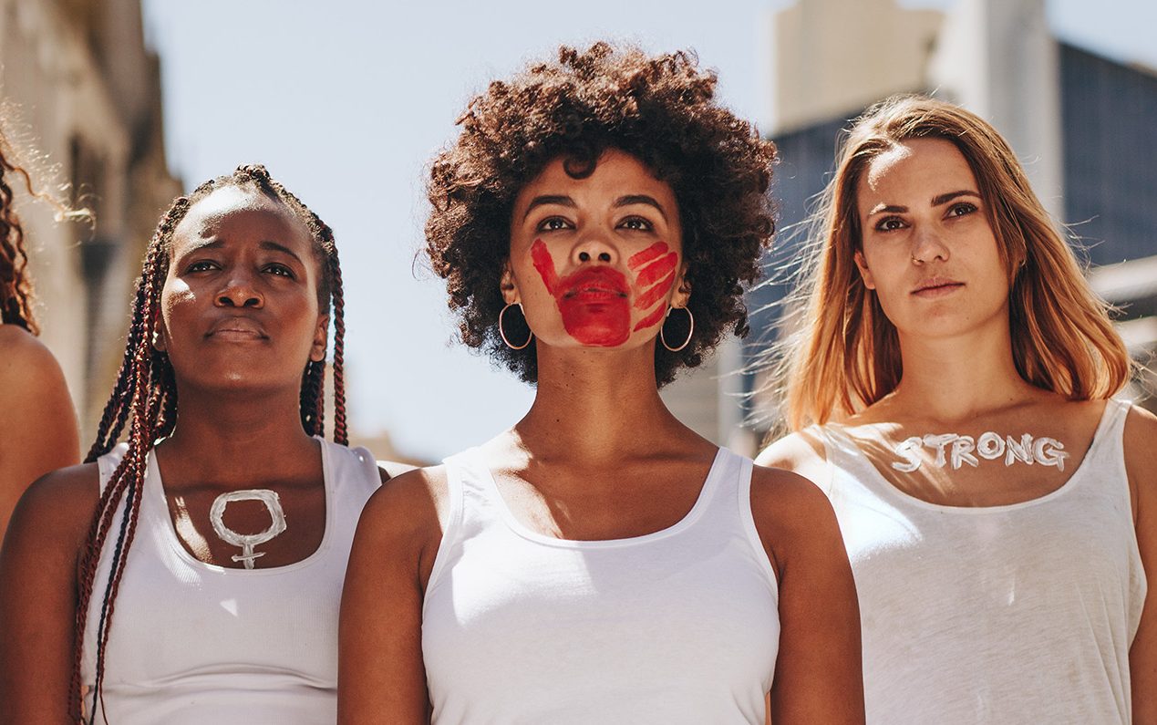 Group of women with words painted on them strong, brave, power