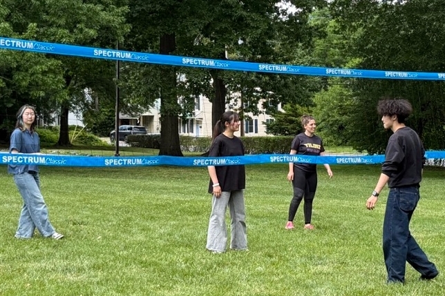 ELI students, including a few Chinese students, play volleyball at the ELI summer picnic.