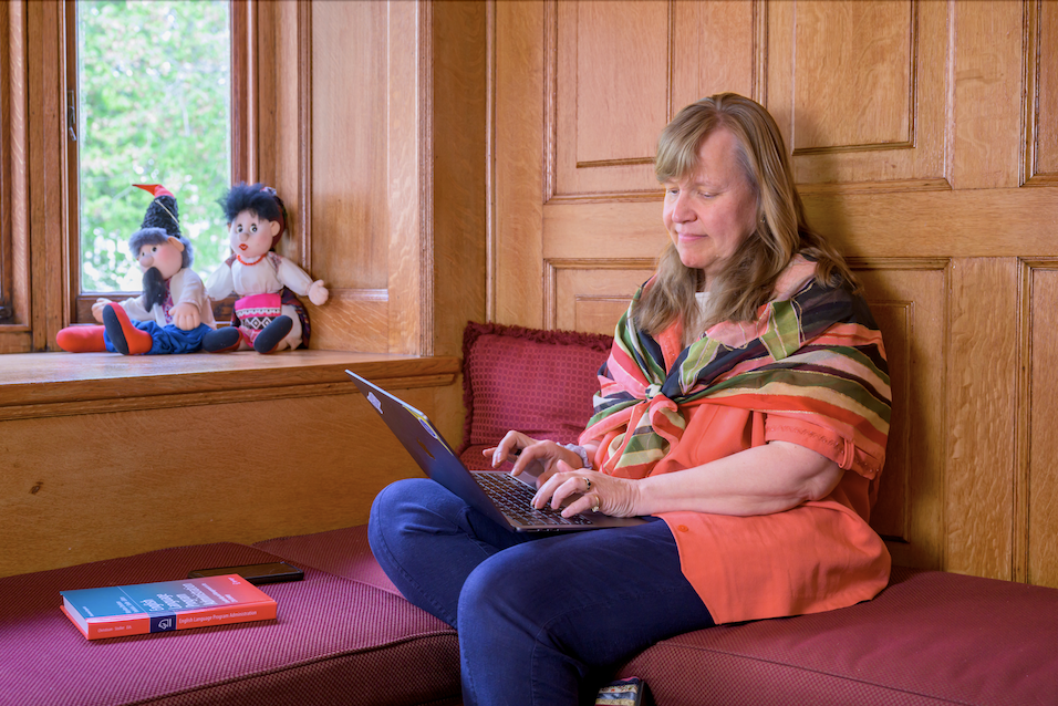 Cheryl Ernst is typing on a computer in the ELI lobby.