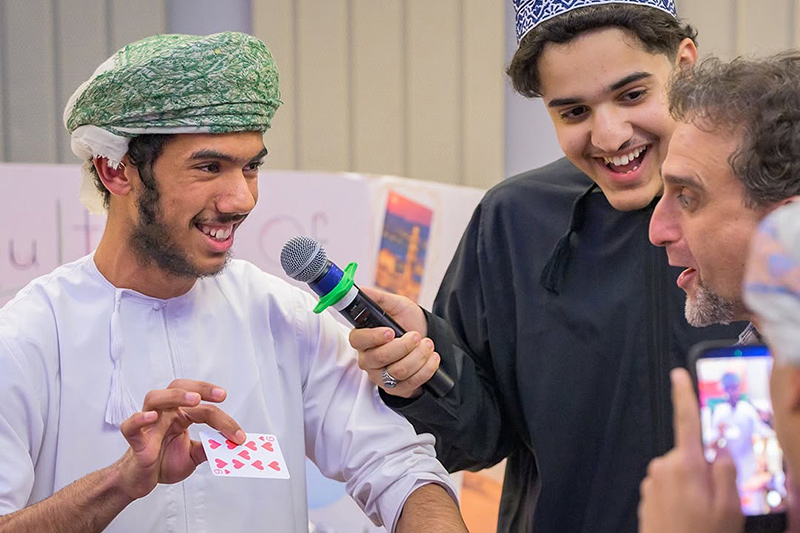 Alyaman al Habsi performs a magic trick at the Festival of Nations