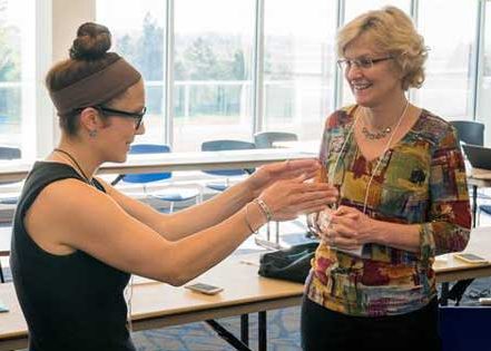 Department of Earth Sciences graduate student Julia Guimond speaks with her mentor, Ann Masse, a CEOE alumna and vice president of safety, health and environment at Barrick Gold Corporation.