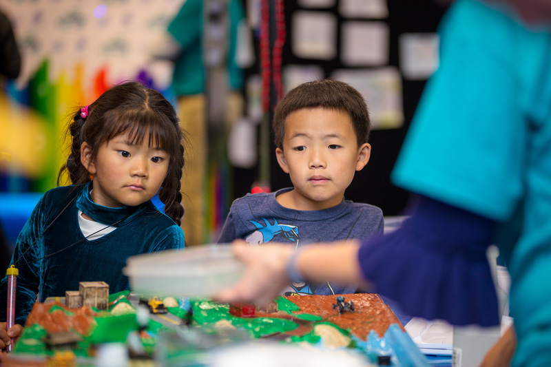 Two children watching an experiment during Coast Day