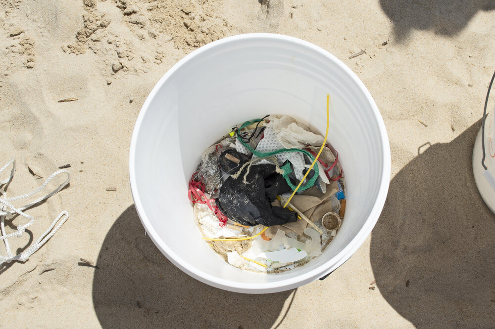 Bucket showing plastics found on beach