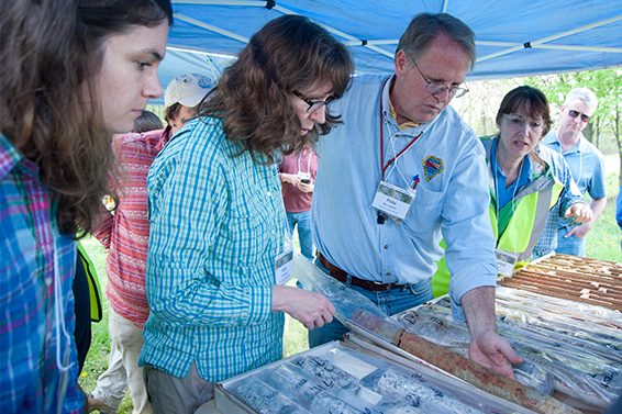 Delaware Geological Survey field experience participants check a core sample.