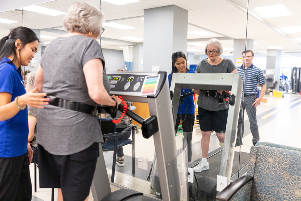 CHS-PT_Clinic_covid19-111220 Clinicians and physical therapy students treat patients during COVID-19, following their new protocol for social distancing and wearing double layers of masks. The PT Clinic hit its 6,000th visit during November 2020.