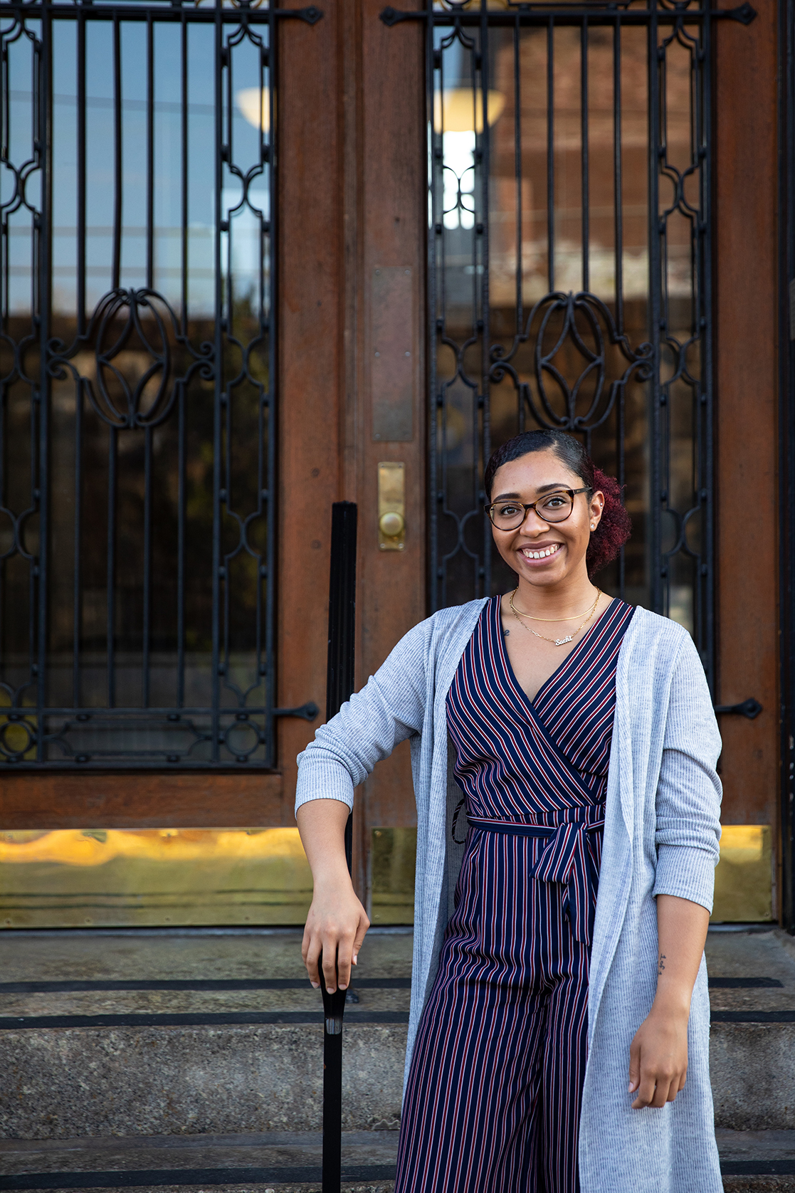 Sachi Brathwaite stands in front of the iron door of a community services building in Wilmington