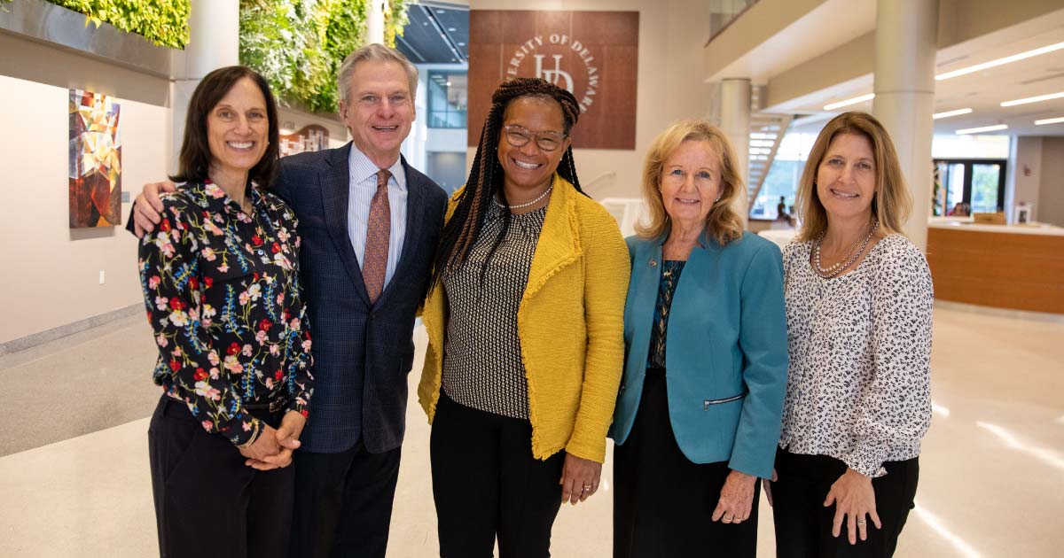 Five professionals posing for a photo at the university