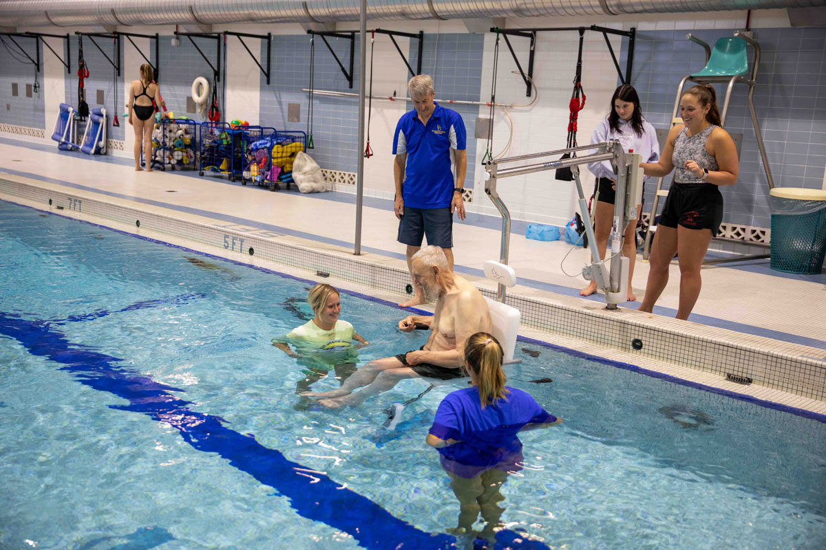 Steve Goodwin and students in the aquatic center for adapted physical activity with community members
