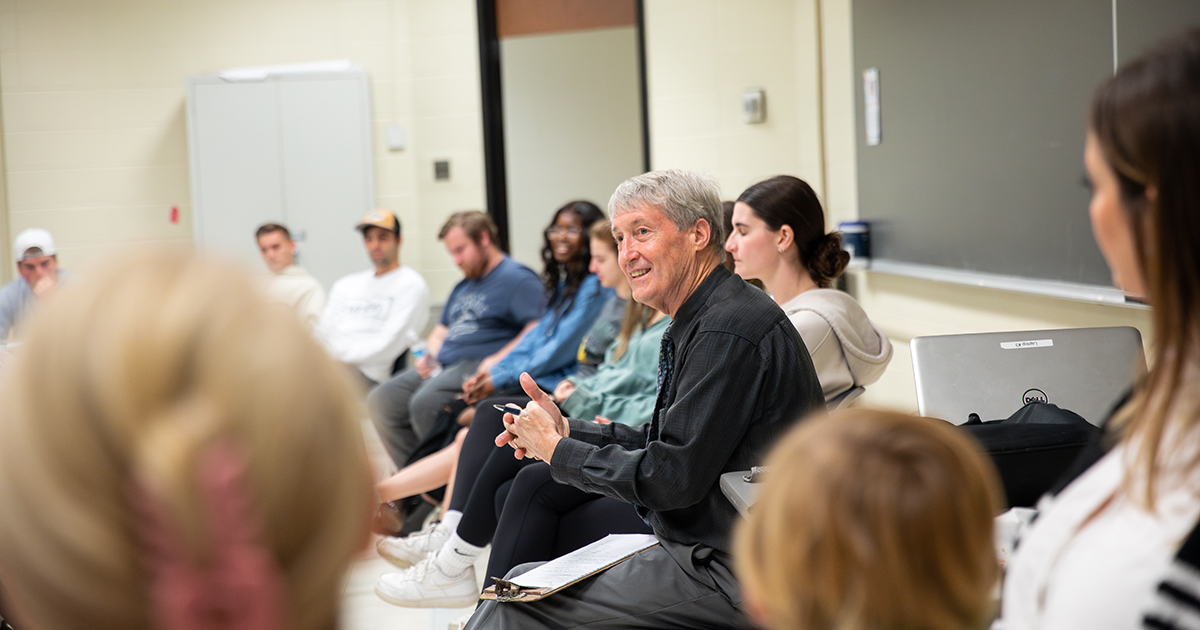 Students sit in a circle in a classroom in Willard Hall, where Dr. Steve Goodwin, associate professor of health behavior and nutrition sciences, leads his Art of Happiness class.