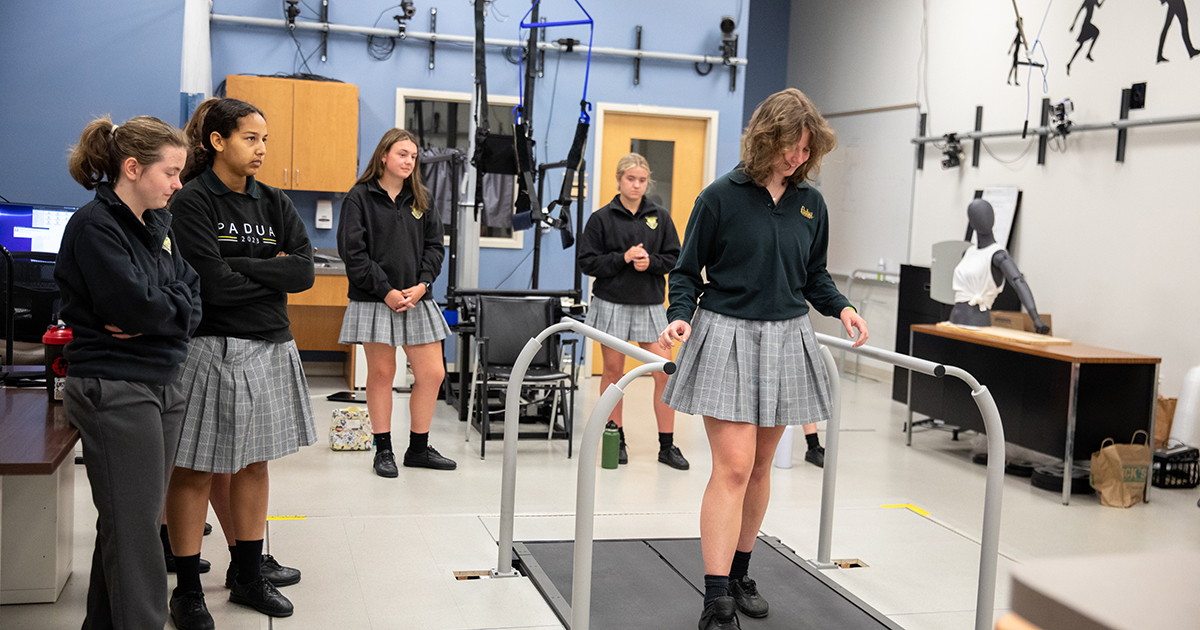 Students from Padua Academy walk on an adaptive treadmill and learn about improved rehabilitation techniques for stroke survivors developed by UD researchers at National Biomechanics Day on STAR Campus.