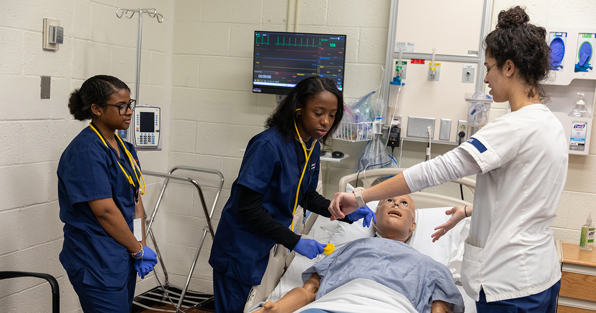 School of Nursing students work with a manikin on a simulation. 