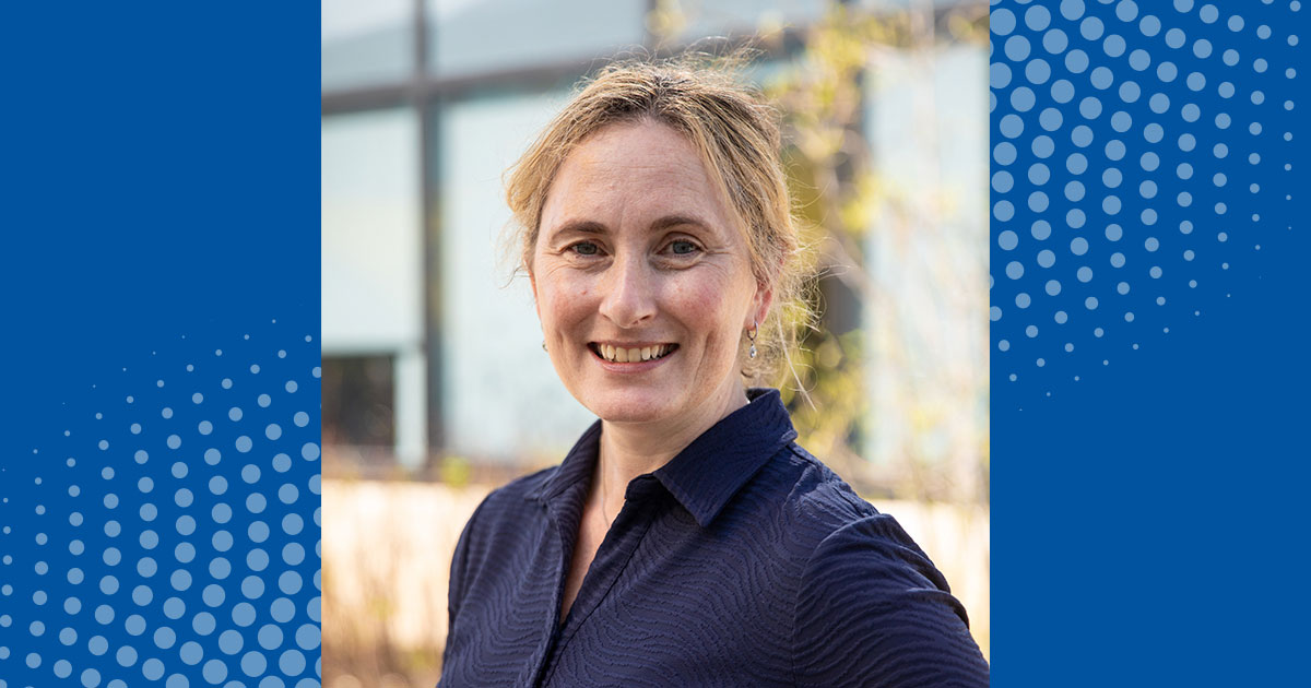 A headshot of Freda Patterson, associate dean of research for the College of Health Sciences, with her hair up outside STAR on a UD blue overlay background. 