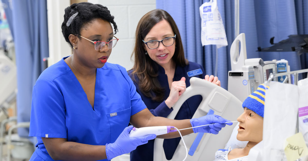 performing endoscopic examinations on patient simulators (mannequins / manikins) in the Center for Simulation Innovation, Interdisciplinary Education, and Entrepreneurship (CSIIDEE) lab in McDowell Hall with a faculty member beside her.