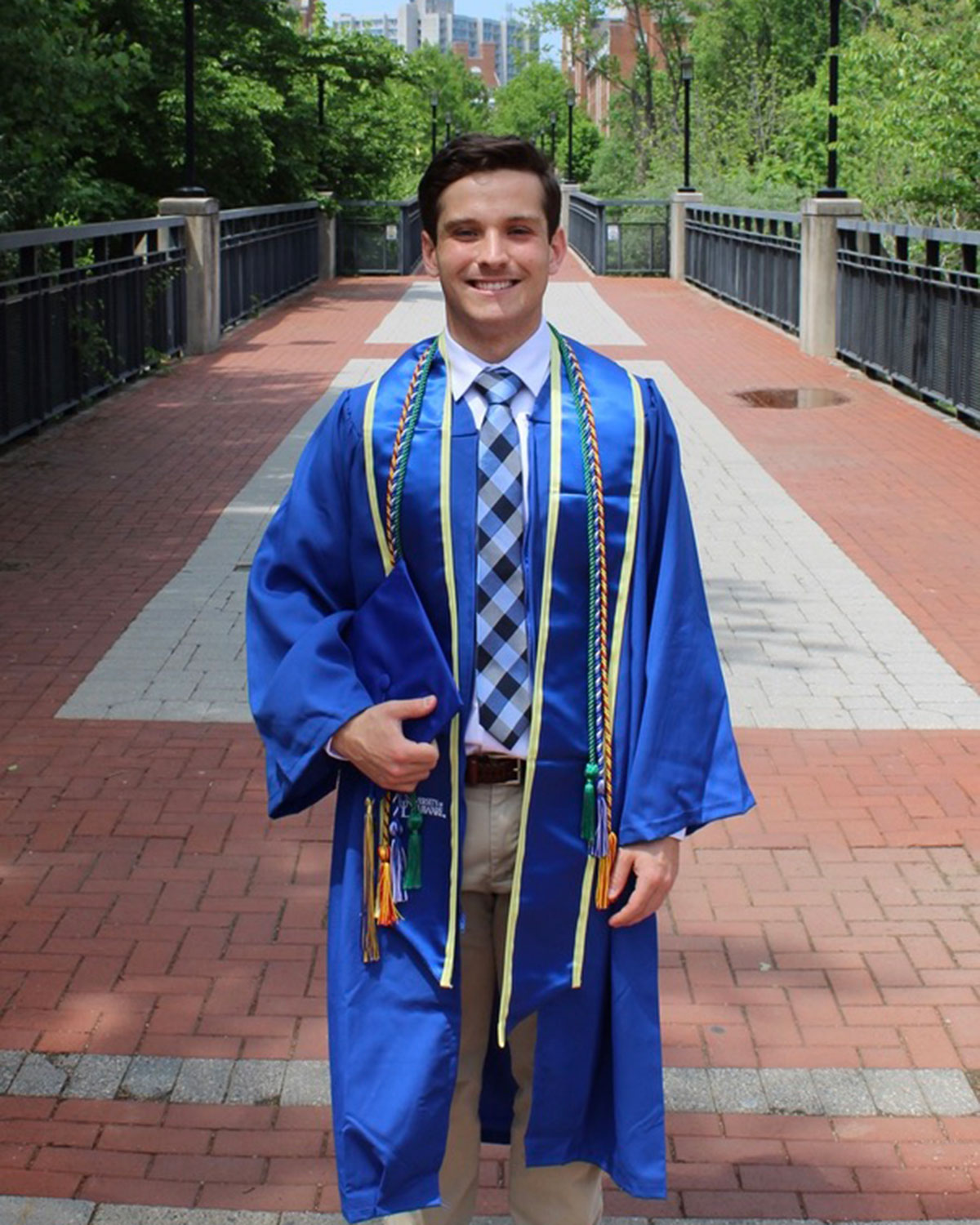 Matthew May, a senior medical diagnostics major with a pre-PA concentration, wears his blue Commencement coat.