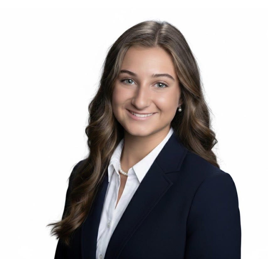 A headshot with a white background of health behavior science major Samantha Papili, wearing a black blazer and a white collared shirt