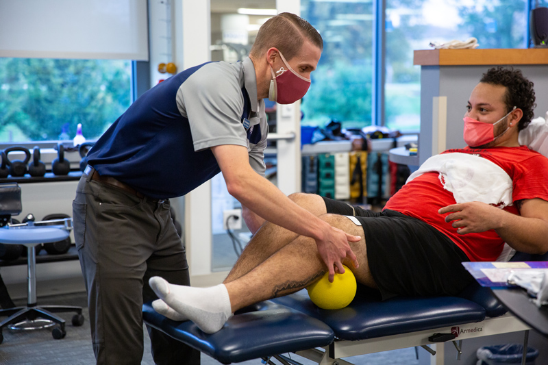 CHS-PT_Clinic_covid19-111220 Clinicians and physical therapy students treat patients during COVID-19, following their new protocol for social distancing and wearing double layers of masks. The PT Clinic hit its 6,000th visit during November 2020.