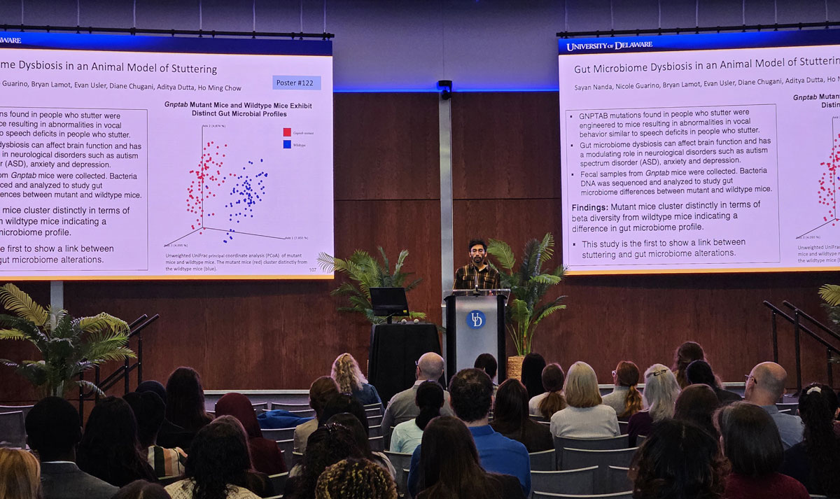 Graduate student giving a presentation on Gut Microbiome Dysbiosis in an animal model of stuttering.