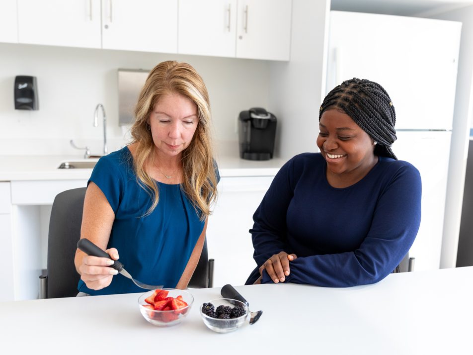 Professor and student examining bowls of fruit