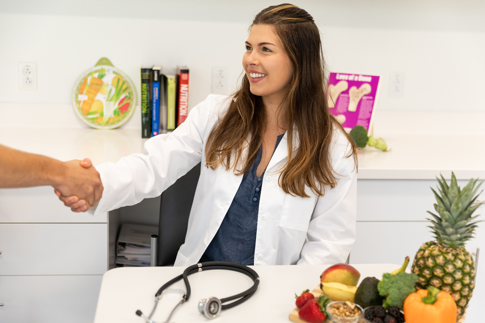 student shaking hands in a nutrition outpatient setting