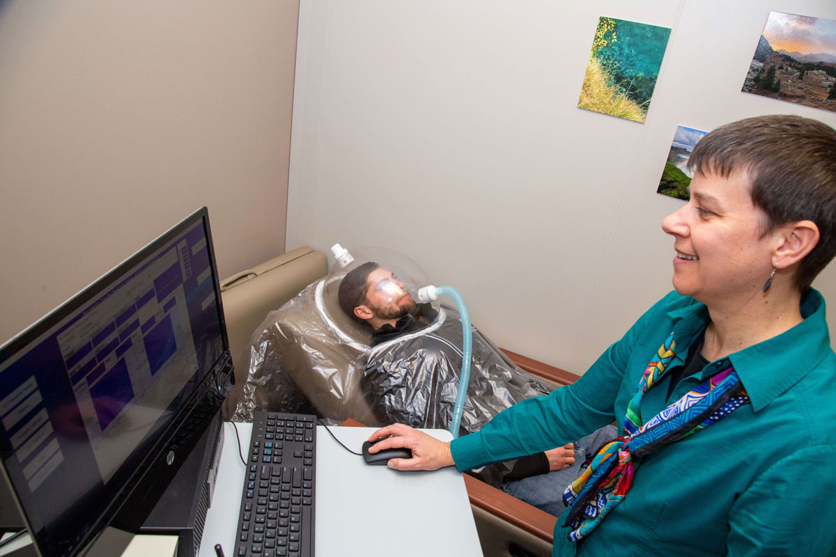 a student uses an instrument in the nutrition science laboratory