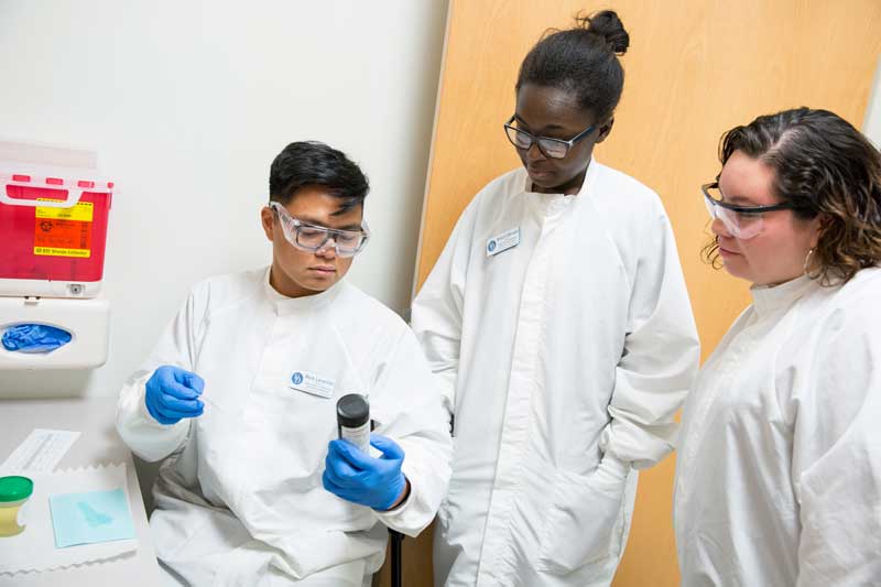 three students in the lab