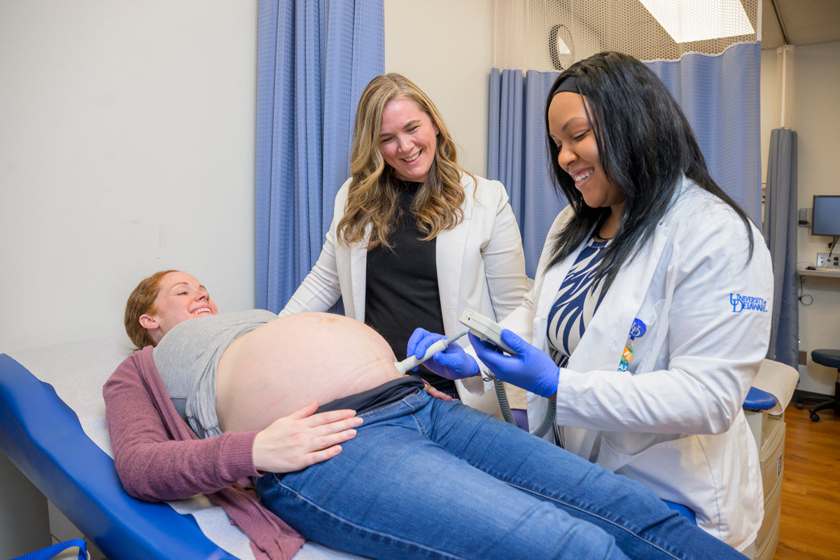 Two nurses monitoring an expecting mother