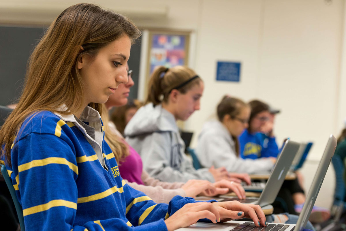 Students working on labtops in a classroom setting