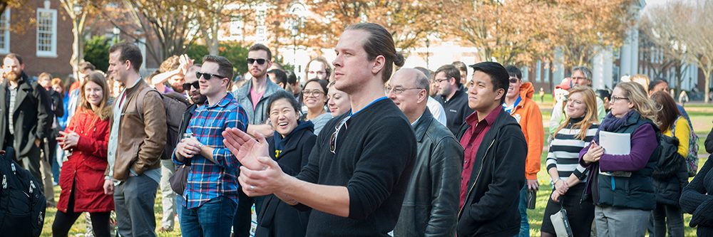 Graduate Students standing on the Green for a rally raising awareness for how a tax reform would impact graduate students.