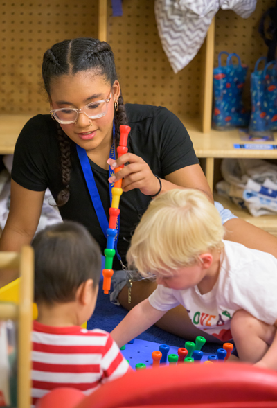 Teacher with students at UD's Early Learning Center