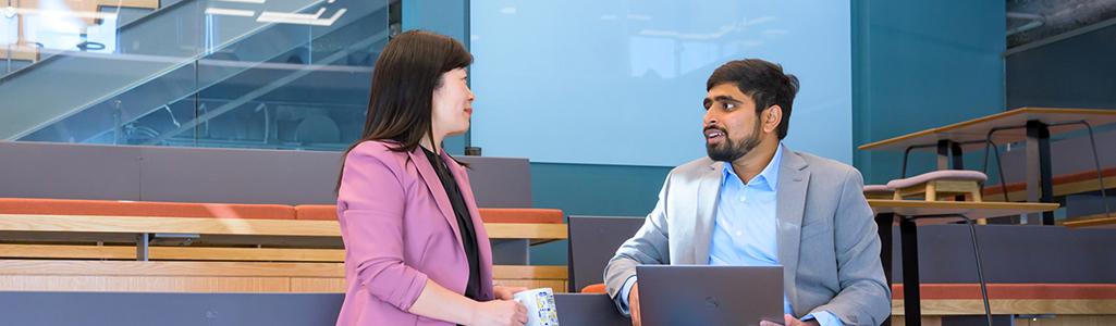 Business Analytics Certificate A business student discussing material with instructor.
