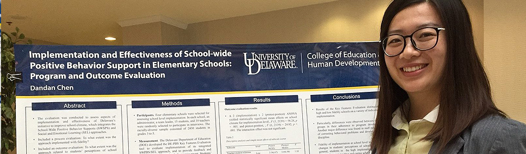 Educational Statistics and Research Methods A graduate student smiles in front of her poster presentation at an Education Symposium.