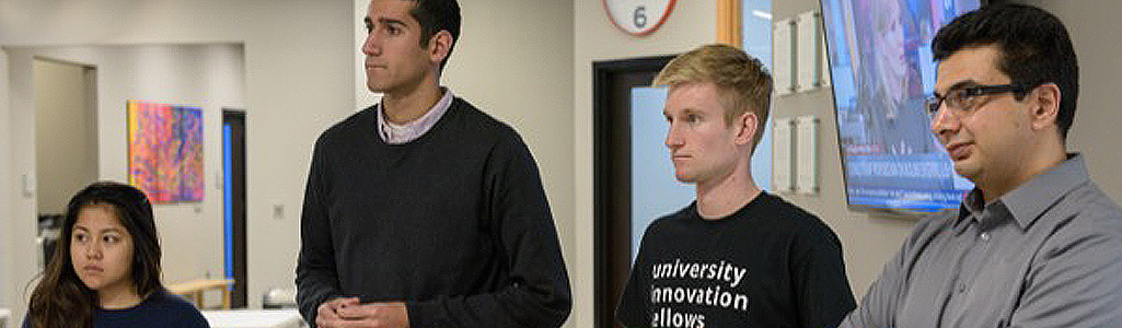 Entrepreneurship and Innovation Four students listening to a presentation
