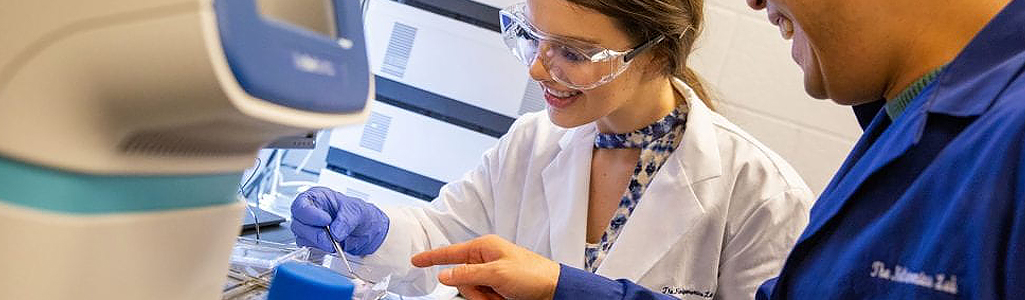 Assistant professor and mater's degree student look at protein expression levels in mice tissue samples that were fed with apiaceous vegetables in the Nutrigenomics Lab in the department of Behavioral Health and Nutrition.