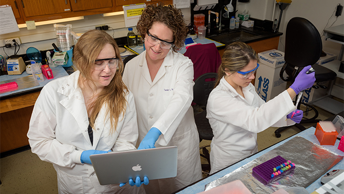PSYCH-Roth_Lab-DNA_Methylation-101816 Tania Roth, assistant professor of Psychological and Brain Sciences, along with graduate students Tiffany Doherty and Samantha Keller in their McKinly Laboratory research space. Roth is the recent recipient of a $1.5m grant to support her further research into neuroscience and DNA methylation. - (Evan Krape / University of Delaware)