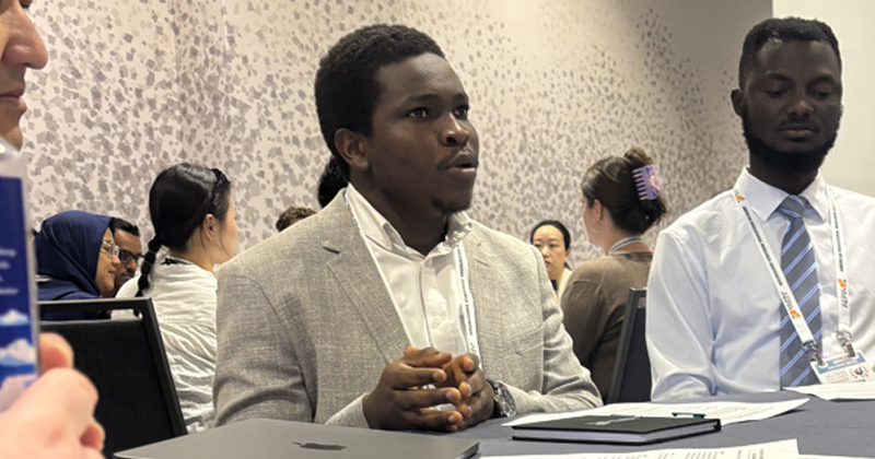 Donatus Doe discussing topic with group
