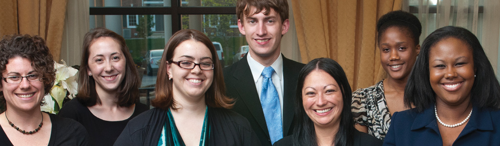 Urban Affairs and Public Policy students in a group shot as they smile during an event.