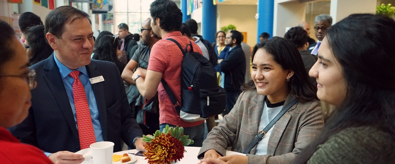 Staff meeting with international students and scholars at international coffee hour