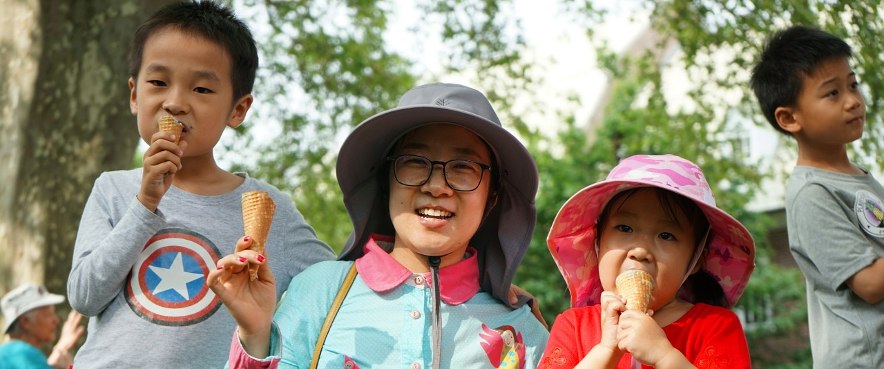 International family members enjoy ice cream at a summer social