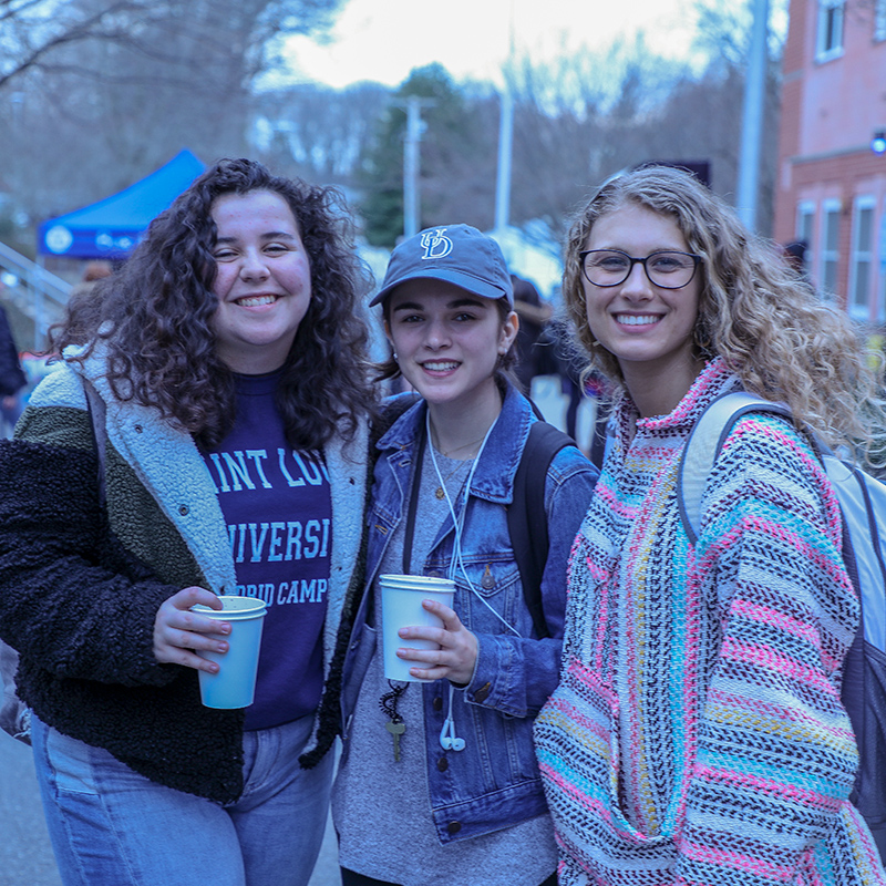 Three World Scholars smile for a photo at the iHouse Block Party