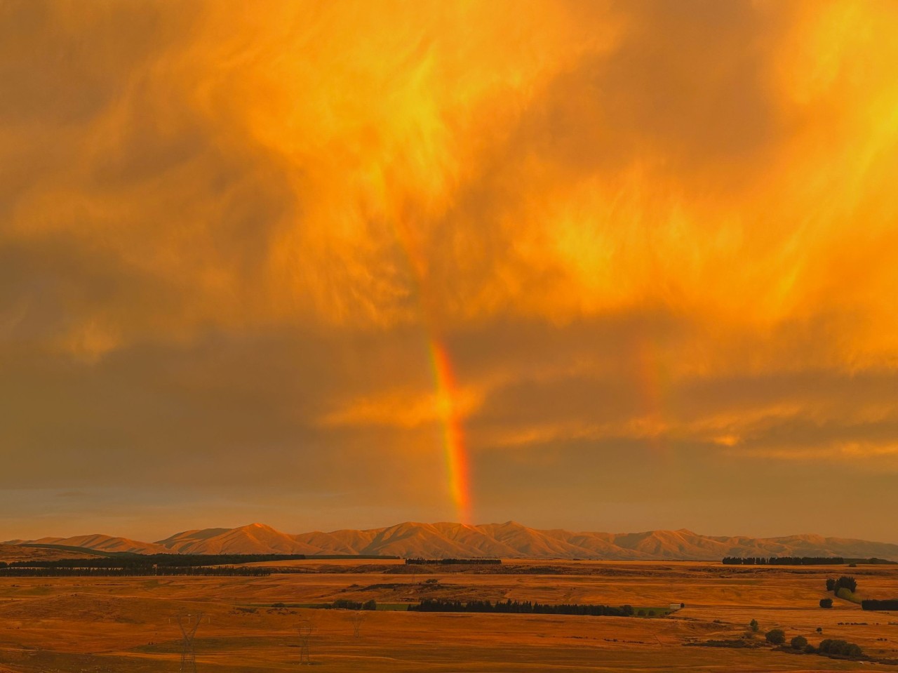 rainbow in an orange sky
