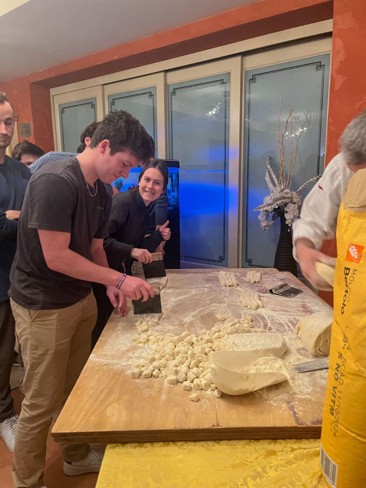 students preparing food on a wood table