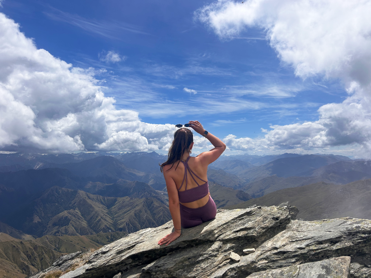 Study Abroad Storytelling Contest winner Student sitting on top of the summit of Ben Lomond