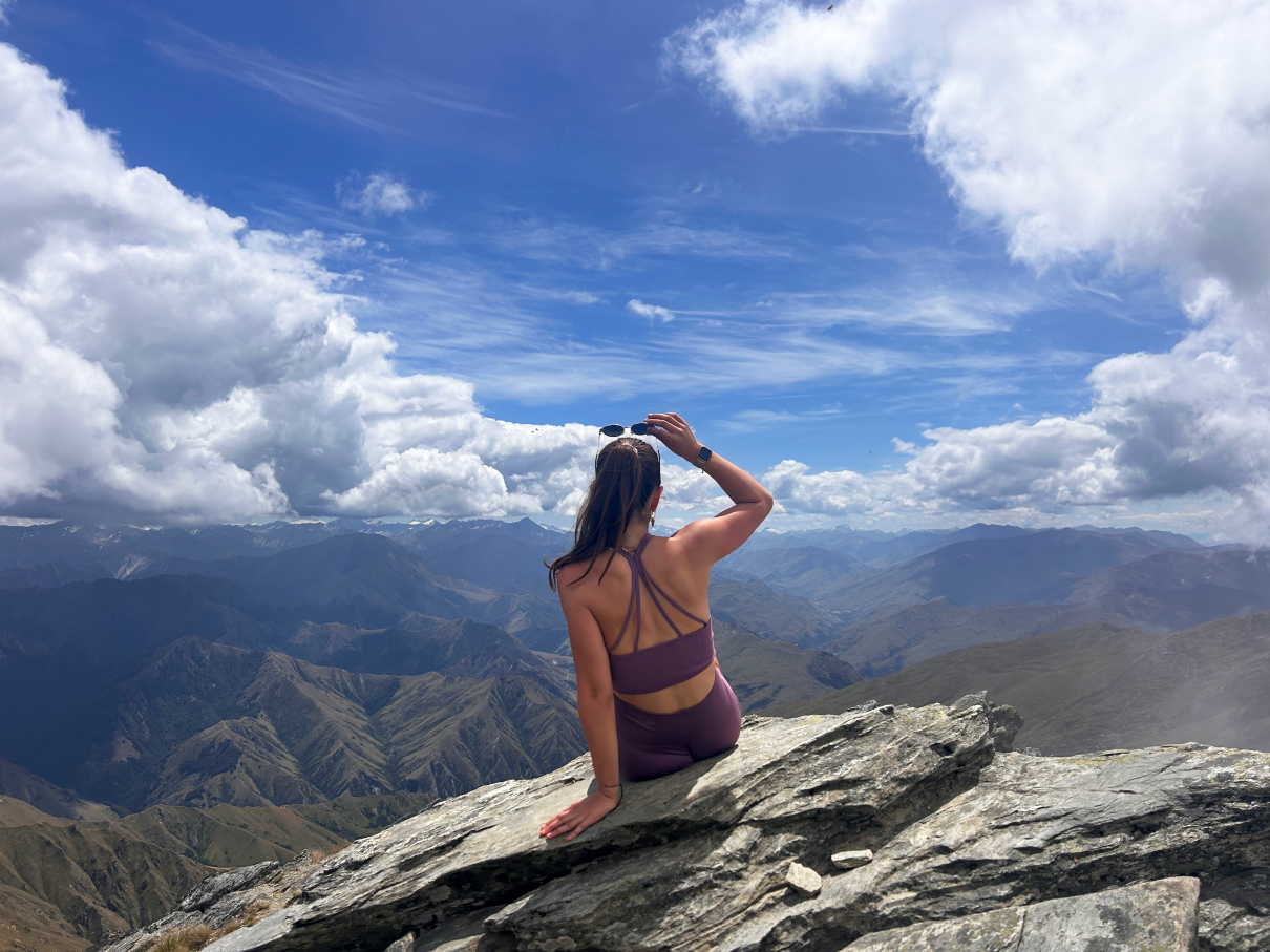 Student sitting on top of  the summit of Ben Lomond