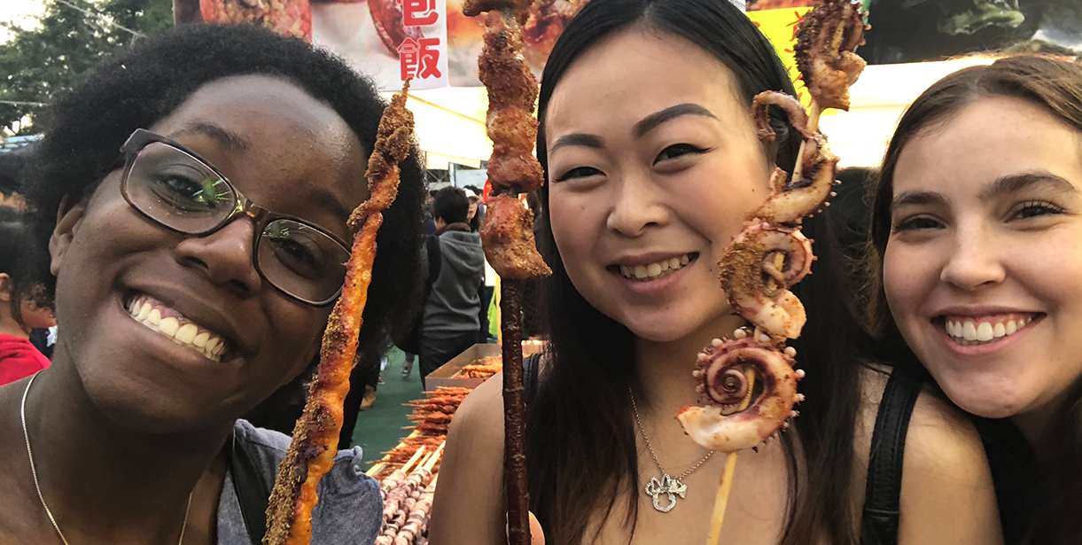 Students pose for a photo with Octopus skewers